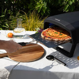 H.Koenig Horno de pizza a gas GINO640, acero inoxidable, 32 cm, superficie giratoria 360 grados, piedra Cordierite, hasta 500°C, pies plegables, pala para pizza y regulador