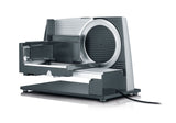 GRAEF Cortafiambres multiusos SKS320 plata, carcasa metálica, cuchilla dentada Ø170 mm de acero inoxidable, diseño compacto, base de cristal, función continua, seguridad infantil, fácil limpieza